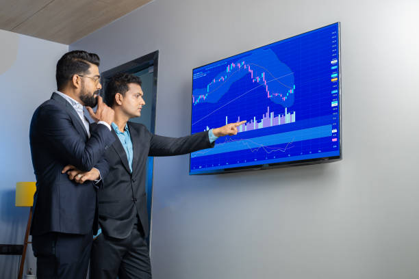 Watching the fluctuations of two broker stocks on the screen