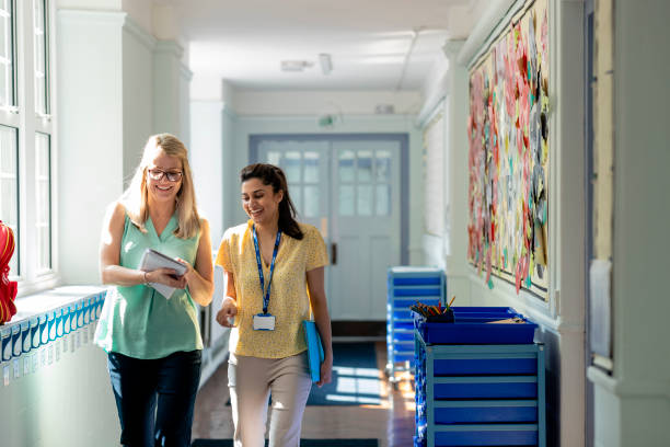 Female principal discusses teaching with female teacher
