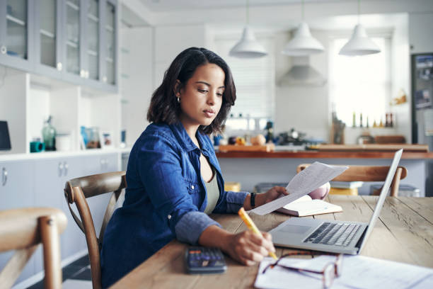 Woman doing office work with the help of laptop in office