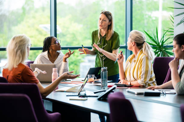 Female officer discusses office staff meeting