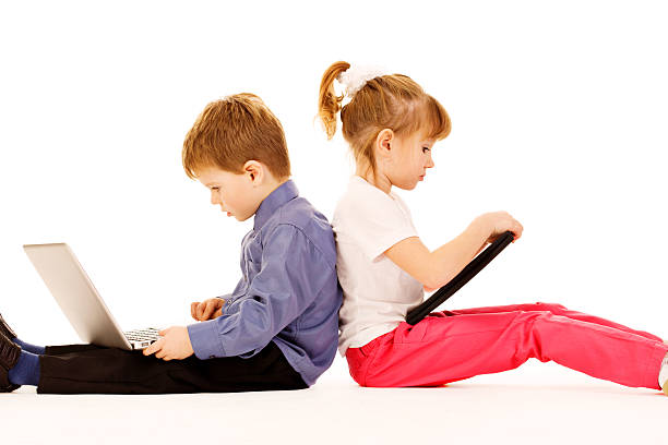 Two tech-impaired children using computers excessively