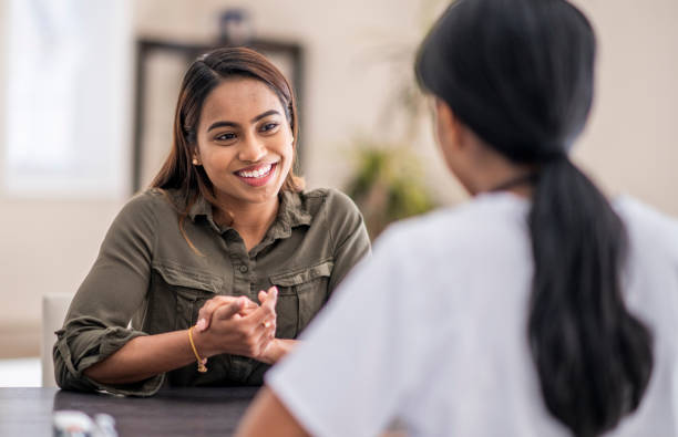Two female students discuss preparing for the exam for appointment to the post of counsellor
