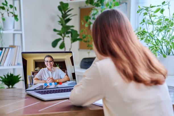 Female student preparing for the selection test for counsellor training with a laptop