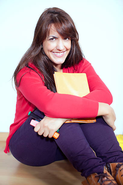 Female student in happy mood after reading
