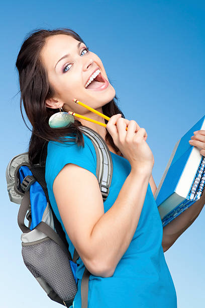 Female student sat down to read the book Eager female student carrying bags and books to college