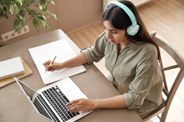 Female student happy to prepare study notes from laptop