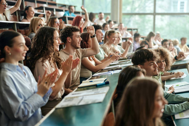 Other students stood up and cheered the student by clapping his hands