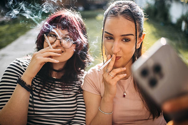 Two girls suffocating on cigarettes