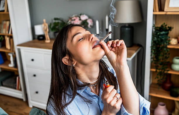 A disoriented young girl takes pleasure in the butt of a cigarette