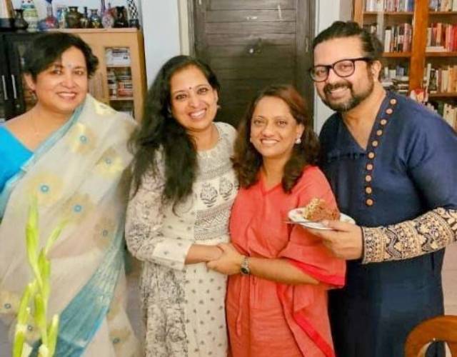 Taslima posing for a photo with her family members in her library