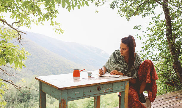 A woman sitting in solitude independently finalizing her article