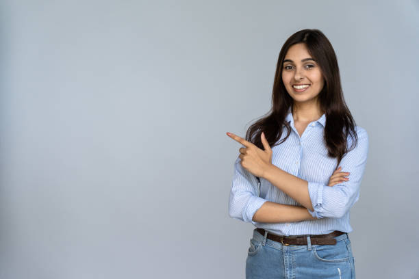 Female student expressing happiness by showing her thumbs up on success