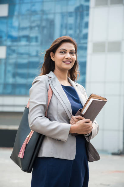 The working woman expressed happiness with the file in her hand on getting success in the job