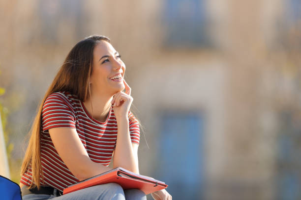 The female student sat with her notebook closed, lost in some other thoughts