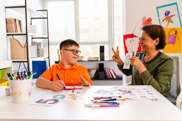Female tutor explaining to a student with her fingers to teach maths