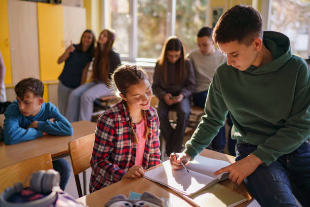 Student explaining math question to female student in class
