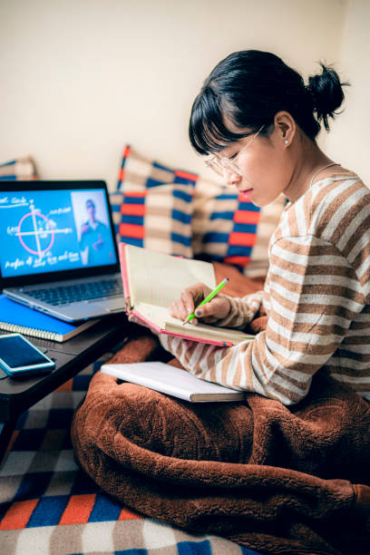 Female student writes from laptop when she doesn't understand math theory