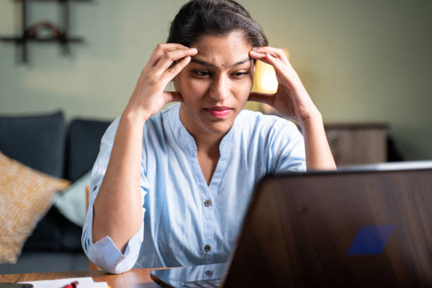 Female student, saddened by educated unemployment, sits with her laptop turned on