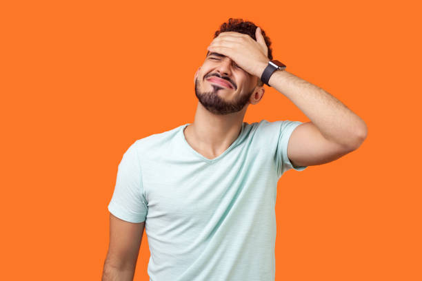 The student puts his hand on his head and tries to get rid of self-guilt