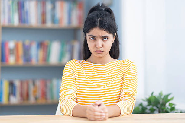 Female student sitting in the study room, feeling guilty