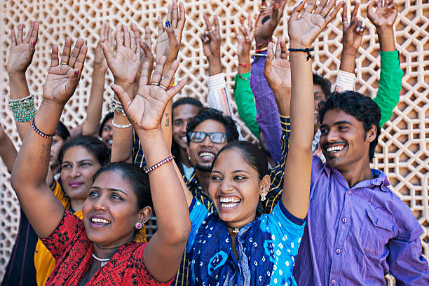 Students with their hands raised in a show of unity as a team