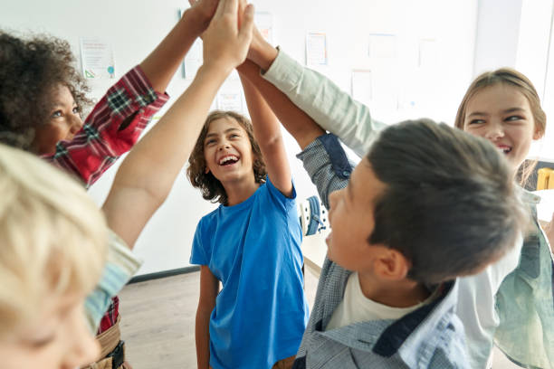 Students holding each other's hands upwards showing unity