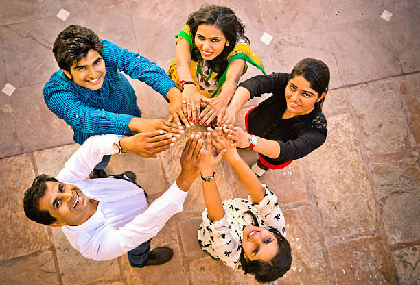 Students as a team with their hands in solidarity