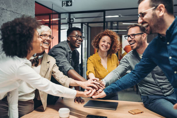 People influenced by corporate culture shake hands with each other with faint smiles