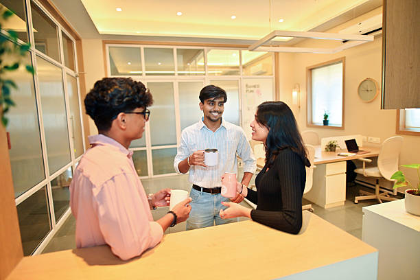 Two girls and a man interact with each other to present a sample of corporate culture