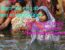 Unity of Science and Philosophy shown through Hindu women in traditional sarees offering water in the Ganges river