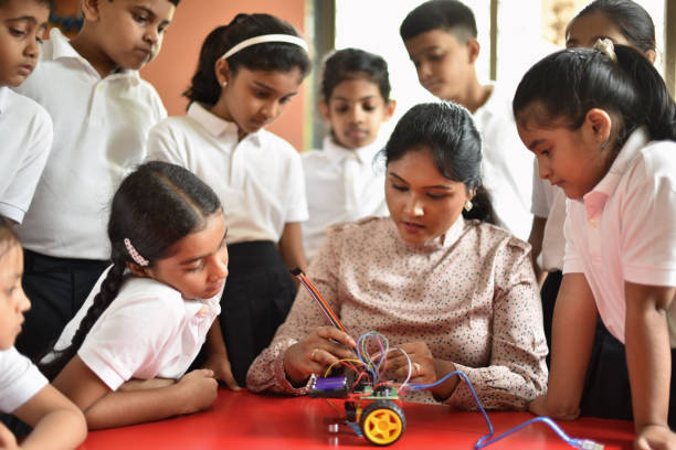 Female teacher explains science topics to students through practical
