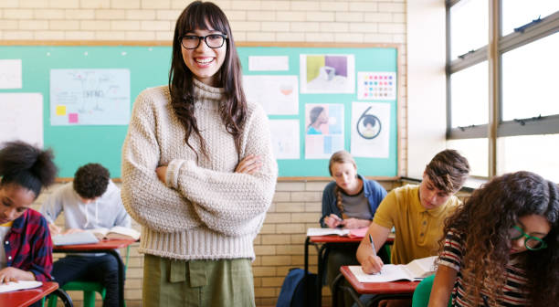 In the classroom, the female teacher takes the math test of the students