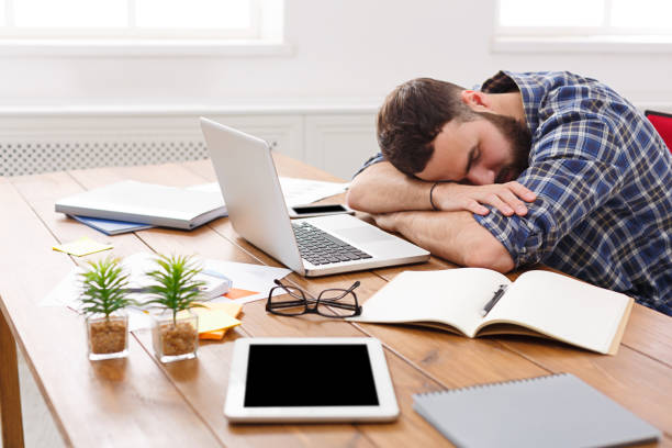 The student fell asleep on the table in the study room after being upset with the study