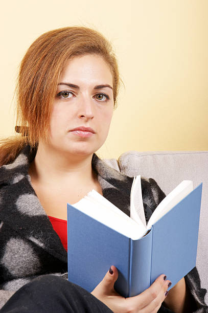 Girl student is wishing success instead of reading a book