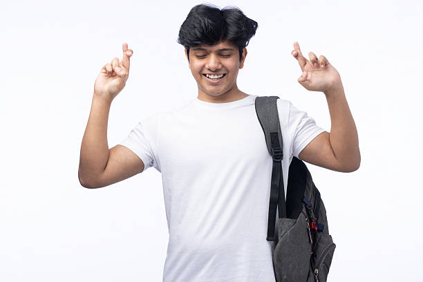 The student raises his hand to express his wish for success