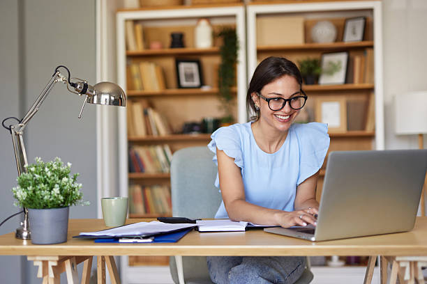Female journalist uploading the latest news from their laptops on the site
