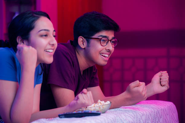 Sister and brother watching objectionable content on TV at home