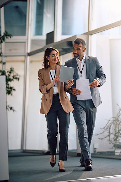 Women are looking at the growth in employees and employee careers on a tablet