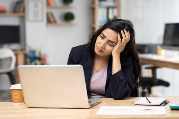 Female employee disappointed when the problem is not solved while working with laptop