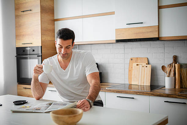 A person drinking tea and reading business related news