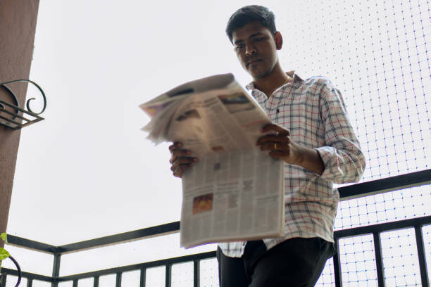 Student looking at their exam related news in the newspaper