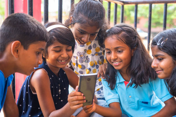 The craze of social platforms in a young child who sits together and uses mobile