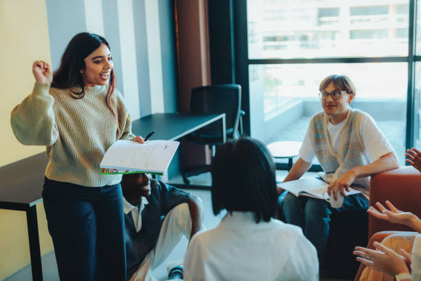 Girl student standing in the classroom and speaking