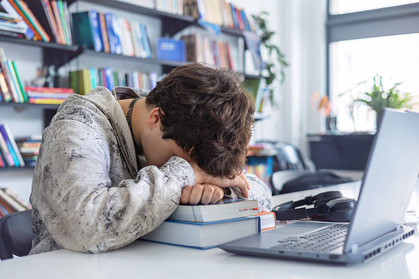 Student upset from studying in real life,with hands over their eyes