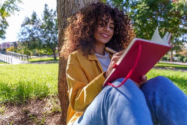 Girl student studying under a tree in solitude instead of reels