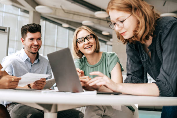 College students discussing religion by studying religion with laptops