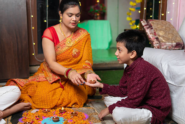 Mother teaching her son about Righteousness through a lamp on religious rituals
