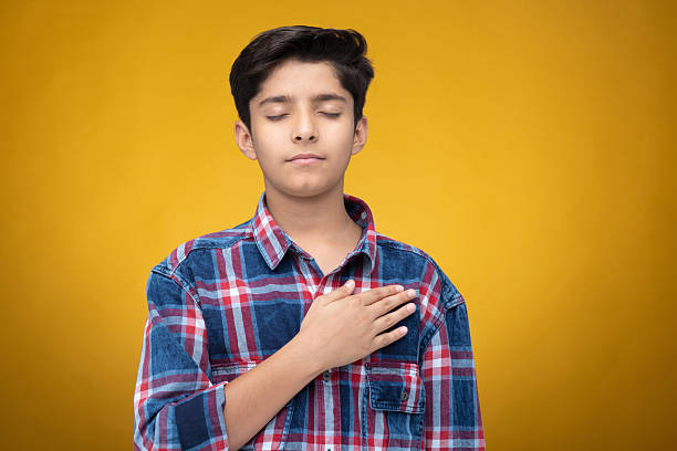 Student resolve to abide by ethical rules with their hands on their hearts