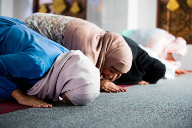 Muslim women prostrating in the mosque