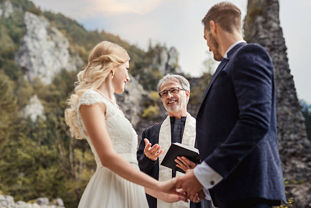 Christian pastors reading the Holy Bible in front of husband and wife